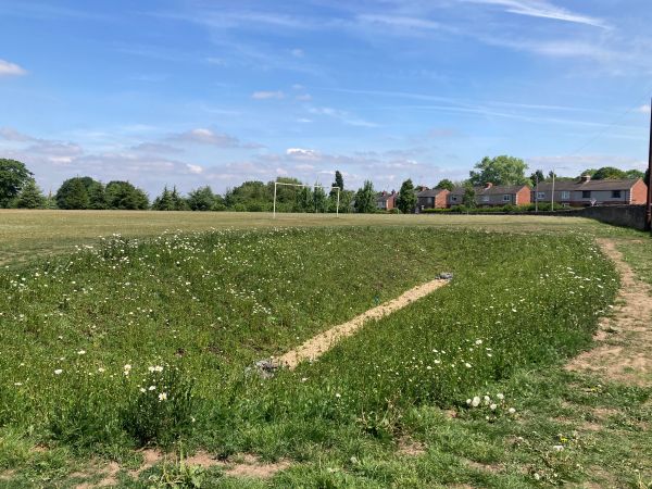 A detention basin on a playing field