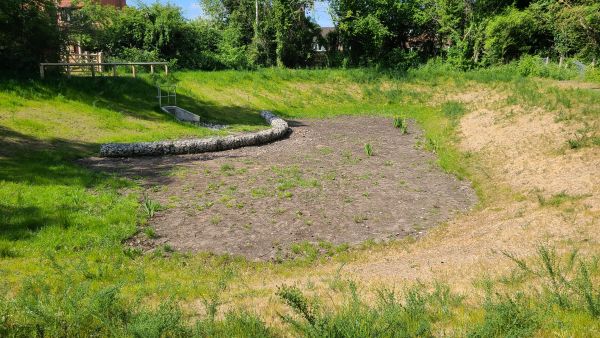 Detention basin with a concrete headwall